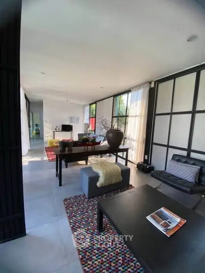 Spacious modern living room with stylish decor and large windows
