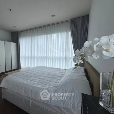 Modern bedroom with large window and elegant decor