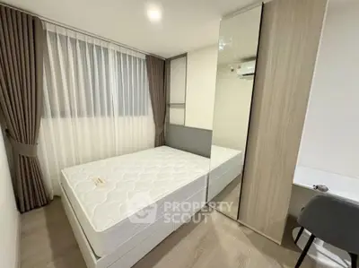 Modern bedroom with sleek design, featuring a comfortable bed, stylish curtains, and a built-in wardrobe.