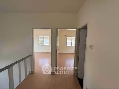 Spacious interior with wooden flooring and natural light, ideal for modern living.