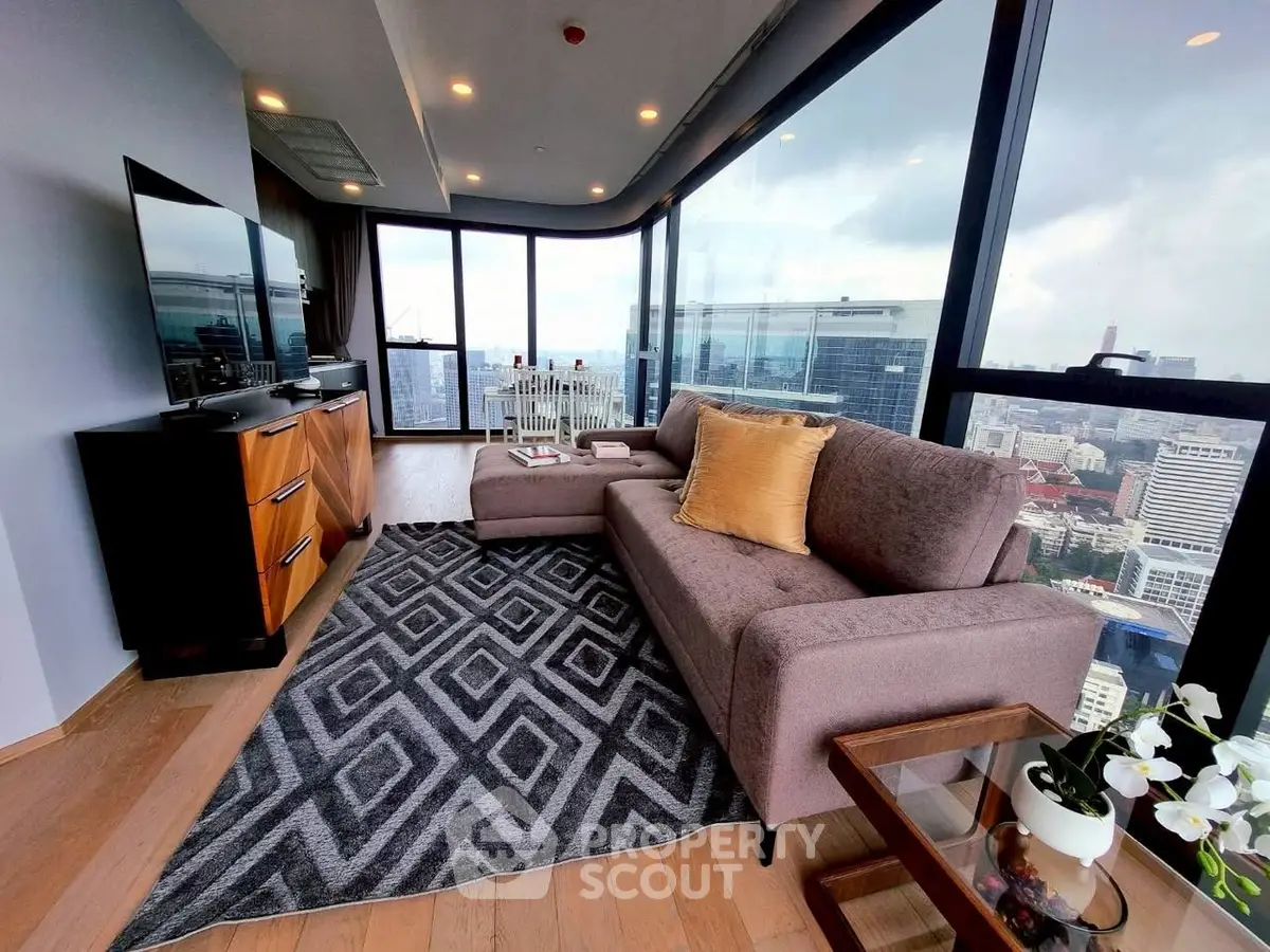 Luxurious high-rise living room with panoramic city views and modern decor.