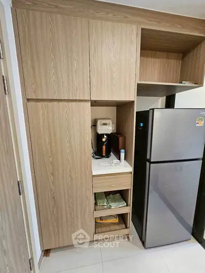 Modern kitchen with sleek wooden cabinets and stainless steel fridge