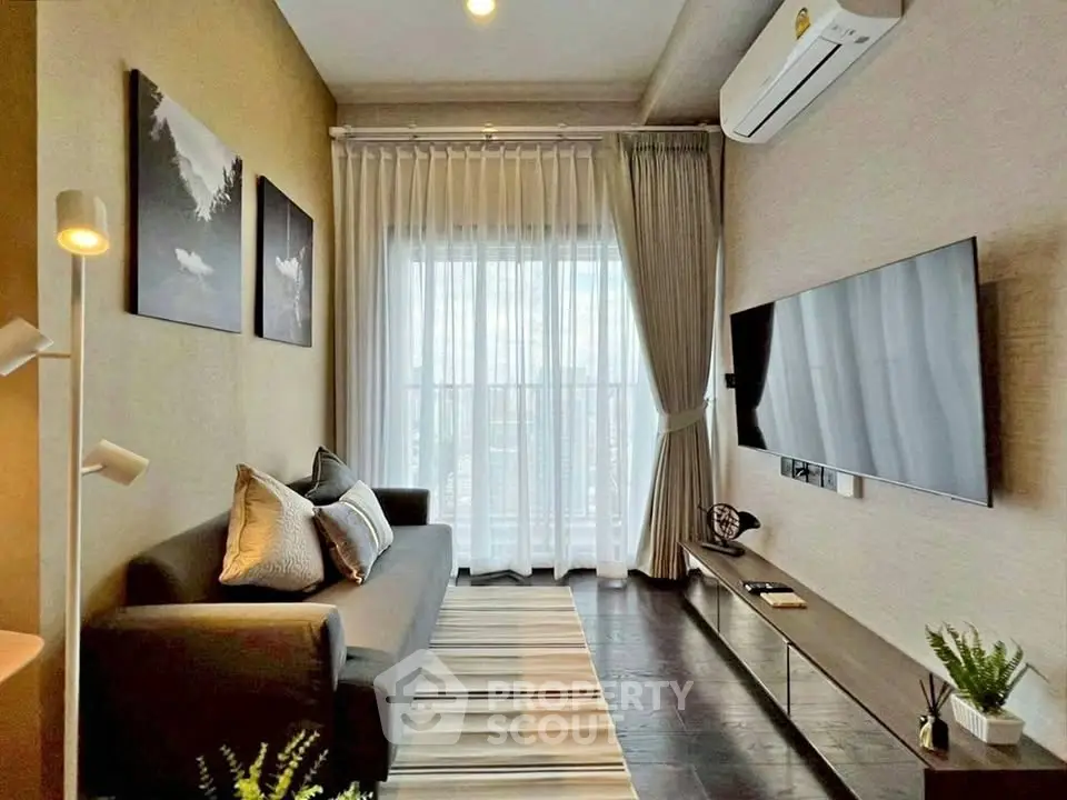 Modern living room with sleek design, featuring a wall-mounted TV, stylish sofa, and large window with curtains.