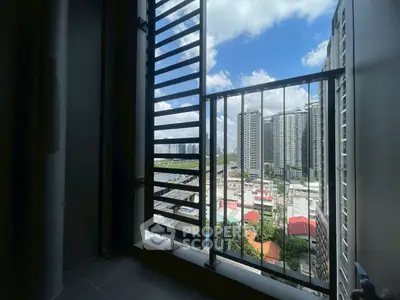 Stunning urban view from a high-rise balcony with city skyline and blue sky.