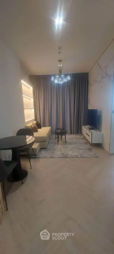 Modern living room with elegant decor, cozy seating, and stylish lighting in a contemporary apartment.
