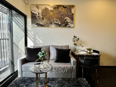 Modern living room with stylish decor and balcony access in urban apartment