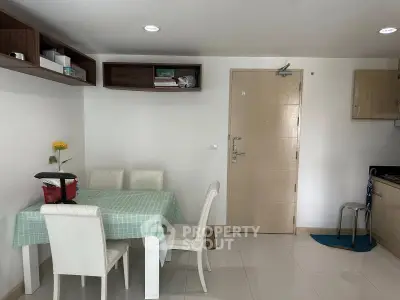 Cozy dining area with elegant white chairs and a stylish table in a modern apartment.