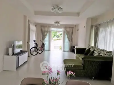 Spacious living room with modern decor and large windows for natural light