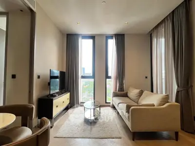 Modern living room with cozy sofa and large windows offering city view