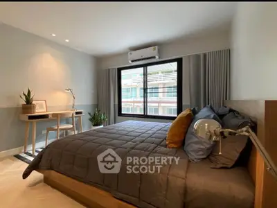 Modern bedroom with stylish decor and large window view