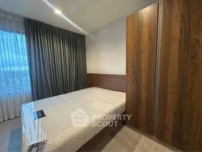 Modern bedroom with wooden wardrobe and large window view