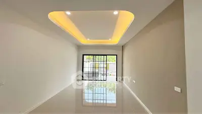 Spacious modern living room with elegant ceiling design and large windows