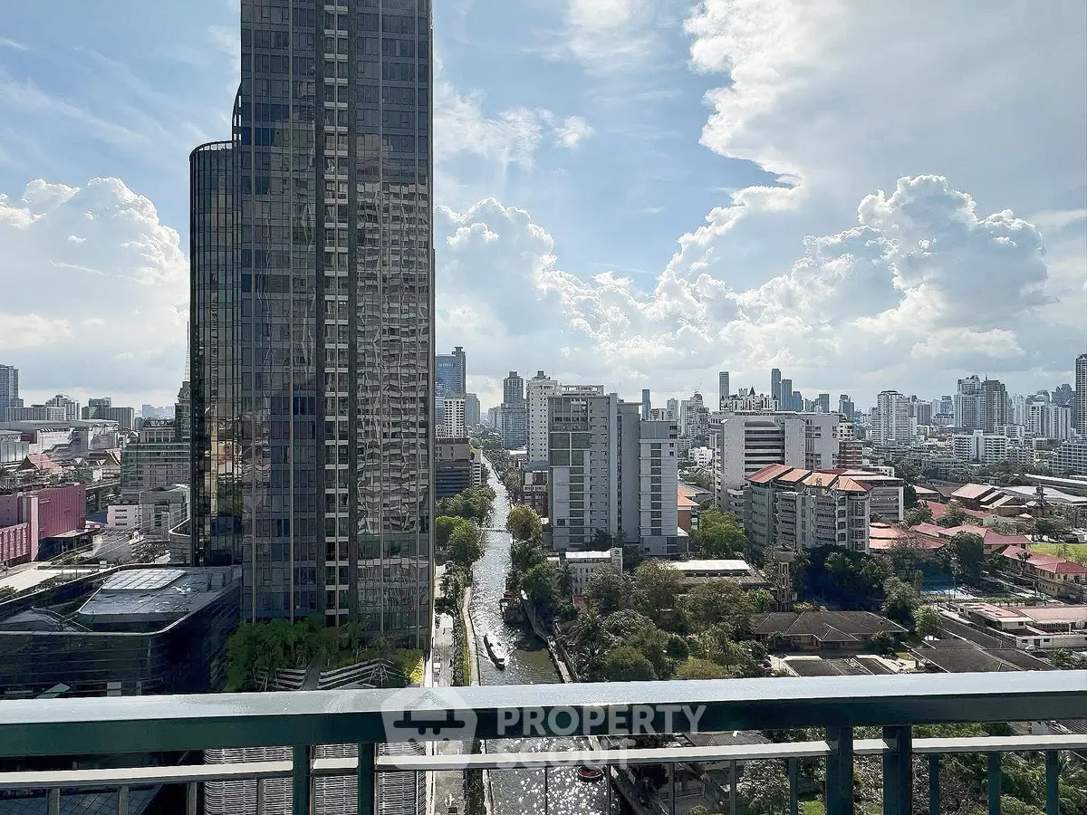 Stunning cityscape view from a high-rise balcony showcasing urban skyline and vibrant city life.