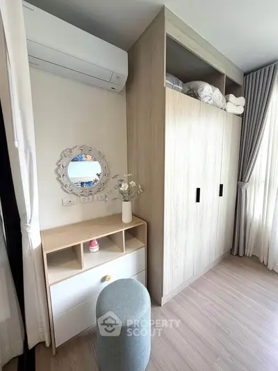 Modern bedroom corner with stylish wardrobe and vanity in bright natural light.