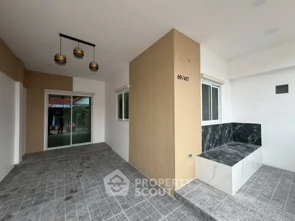 Modern entrance with stylish tile flooring and elegant lighting, perfect for welcoming guests.