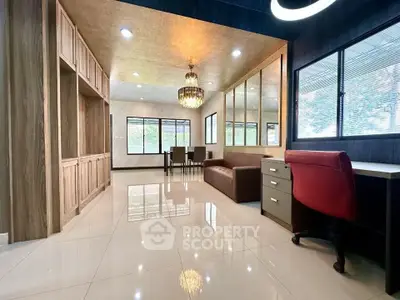 Spacious modern living room with elegant chandelier and large windows