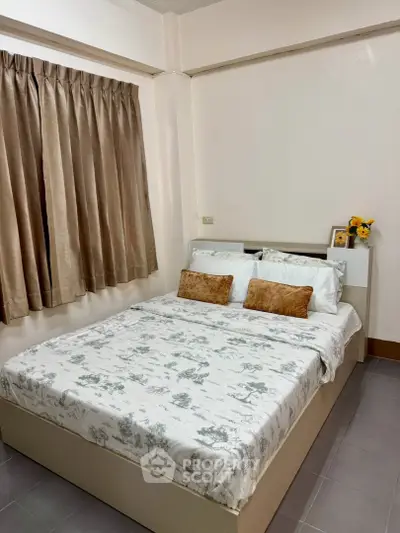 Cozy bedroom with elegant decor and natural light, perfect for relaxation and comfort.