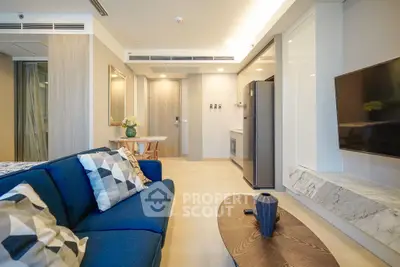 Modern living room with stylish decor and open kitchen layout in a contemporary apartment.