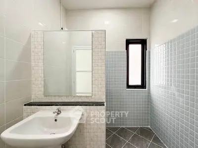 Modern bathroom with sleek tiles and stylish sink in a contemporary home.
