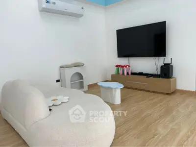 Modern living room with sleek TV setup and cozy seating
