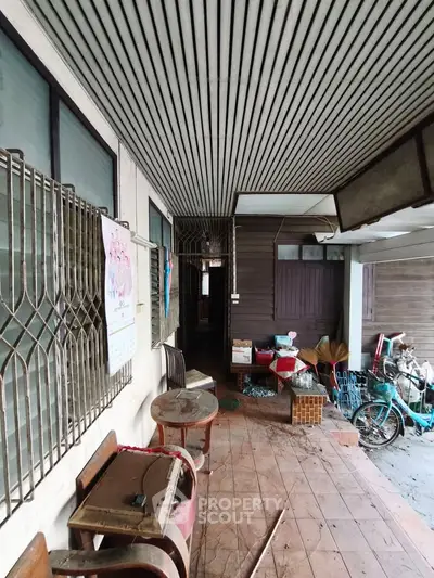 Charming rustic exterior with vintage furniture and tiled flooring, perfect for renovation enthusiasts.