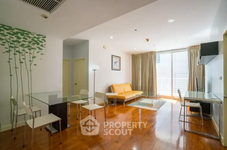 Spacious modern living room with wooden flooring and natural light