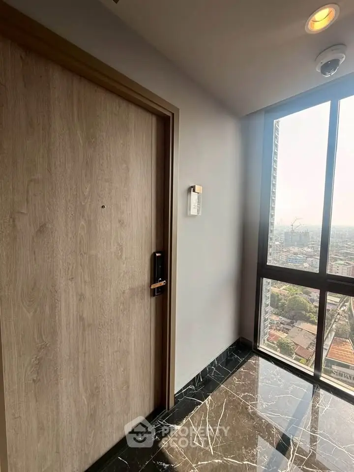 Modern apartment entrance with city view and sleek marble flooring