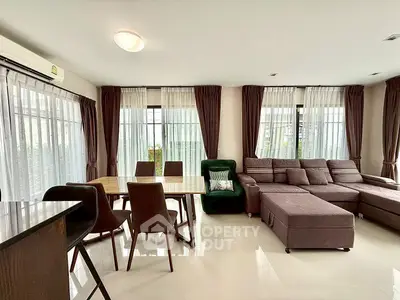 Spacious living room with modern furniture and large windows for natural light.