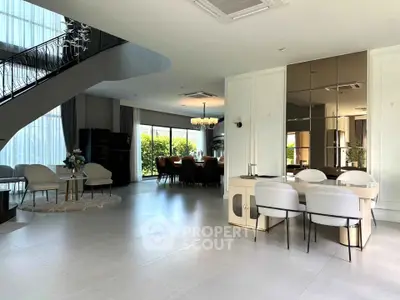 Luxurious open-plan living and dining area with modern decor and large windows.