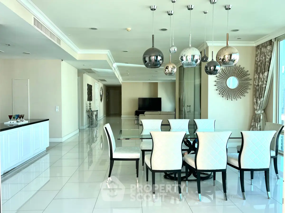 Luxurious dining area with elegant decor and modern lighting in a spacious open-plan layout.