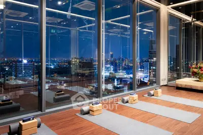 Luxurious high-rise yoga studio with panoramic city views, perfect for relaxation and fitness enthusiasts.