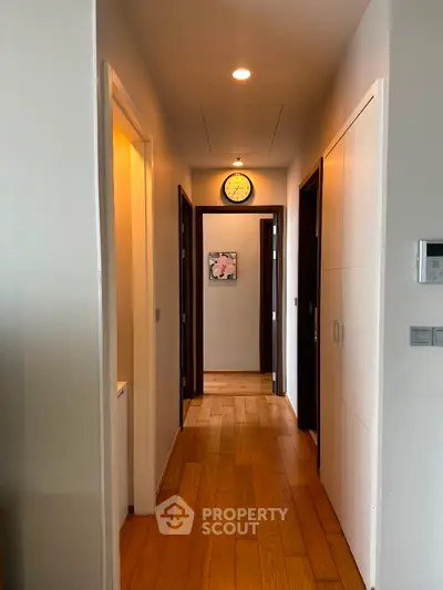 Modern hallway with wooden flooring and stylish decor in a contemporary home