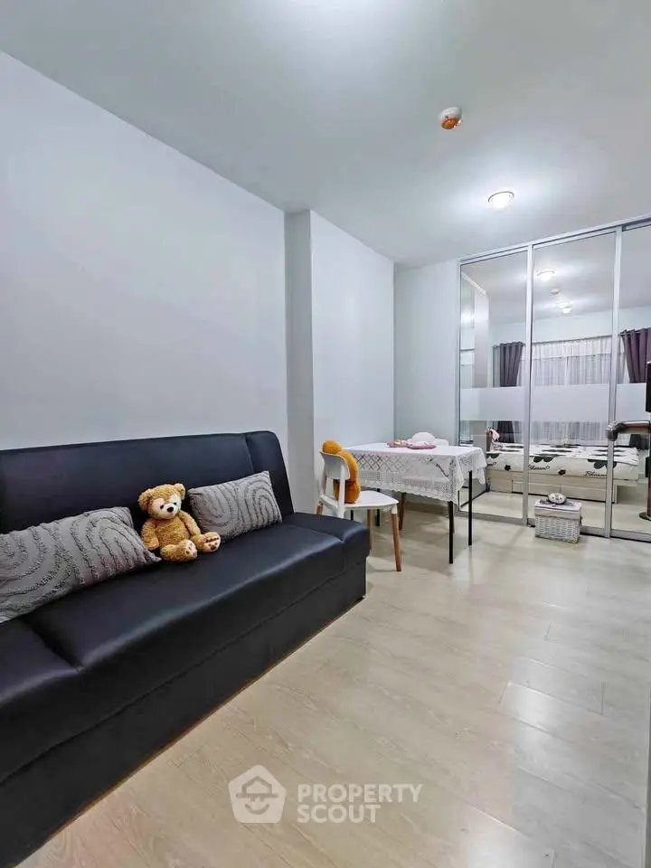 Cozy living room with modern decor and mirrored wardrobe, perfect for relaxation and style.