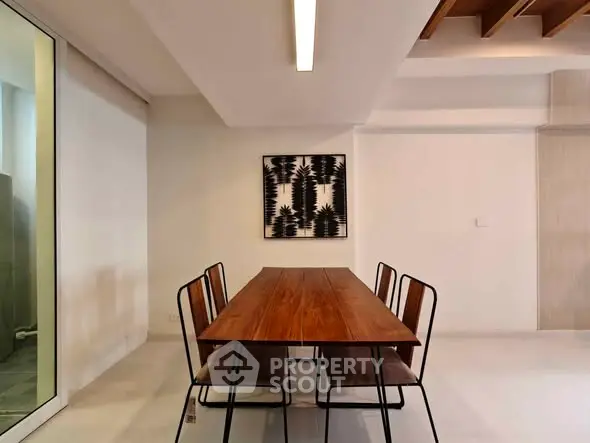 Modern dining area with sleek wooden table and minimalist decor