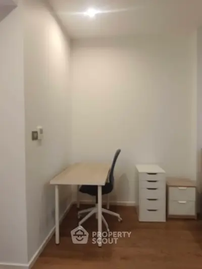 Cozy study area with modern desk and chair in a minimalist design.