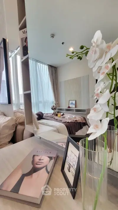 Modern bedroom with elegant decor and large window for natural light