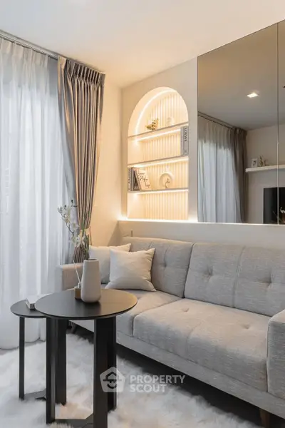 Modern living room with elegant gray sofa and stylish decor