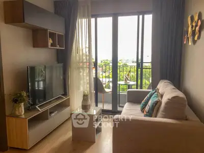 Chic living room with modern decor and balcony view, perfect for urban living.