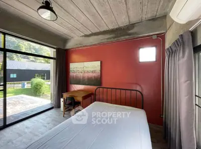 Modern bedroom with large windows and scenic view, featuring minimalist decor and natural light.