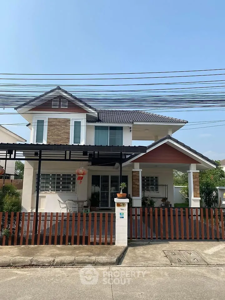 Charming two-story house with modern design and fenced yard in a serene neighborhood.