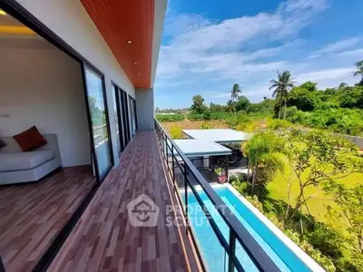 Expansive balcony with breathtaking views, modern design, and seamless indoor-outdoor living in a lush tropical setting.