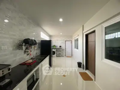 Spacious modern kitchen with sleek countertops and ample storage space