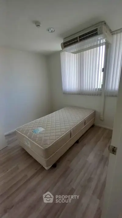 Cozy minimalist bedroom with single bed and air conditioning