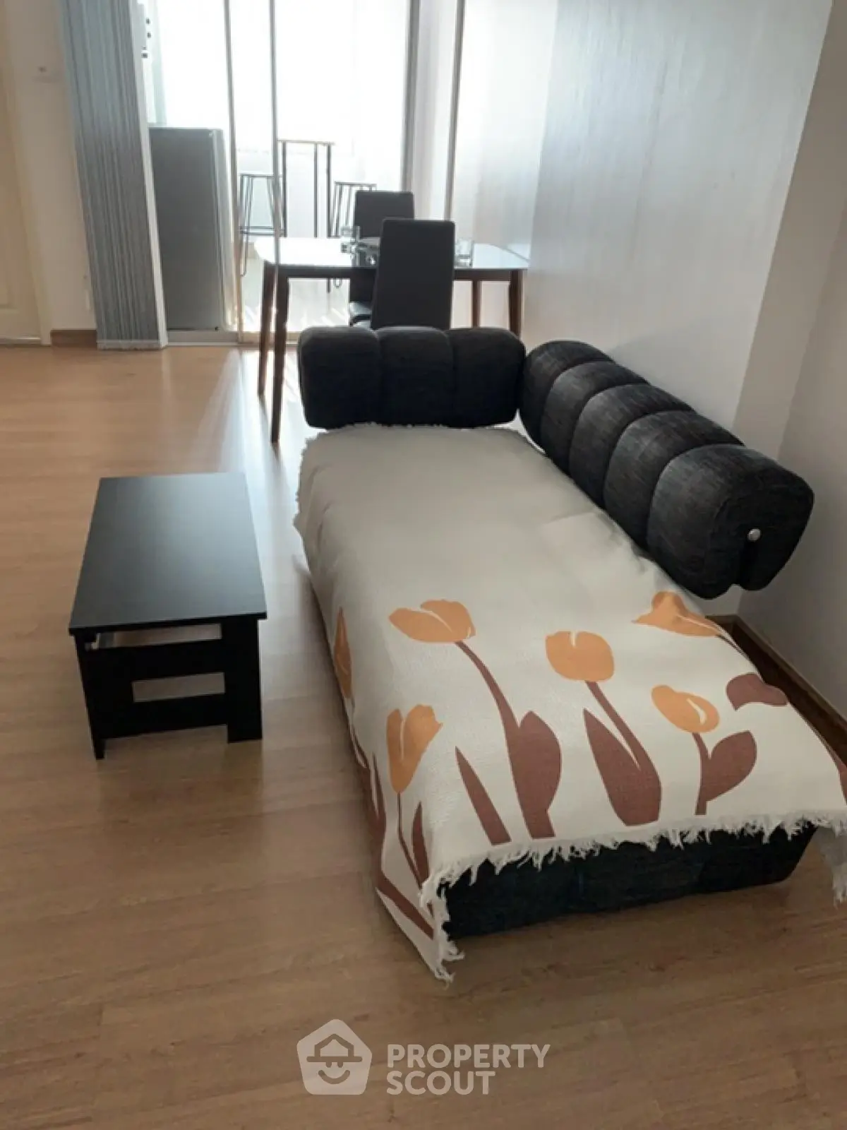 Modern living room with stylish sofa and dining table, perfect for cozy gatherings.