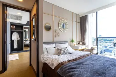 Luxurious bedroom with city view, elegant decor, and ample natural light.