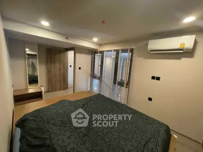 Modern bedroom with air conditioning and stylish decor in a cozy apartment.
