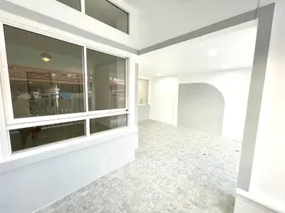 Spacious modern balcony with tiled flooring and large windows