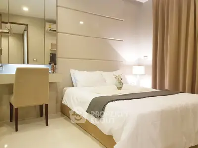 Elegant bedroom with modern decor and cozy ambiance, featuring a comfortable bed and stylish furnishings.