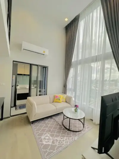 Modern living room with high ceilings and city view, featuring a cozy sofa and stylish decor.