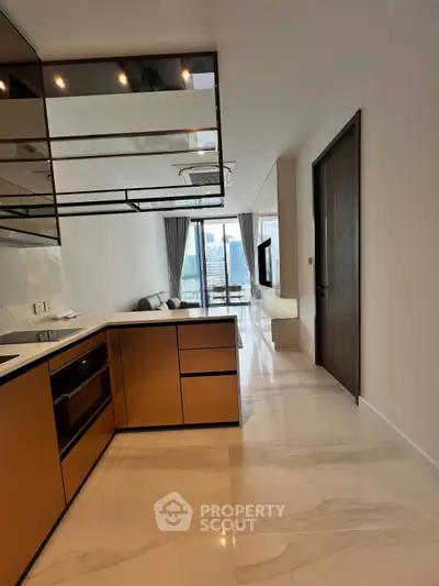 Modern kitchen with sleek cabinetry and open layout leading to a bright living area with city views.